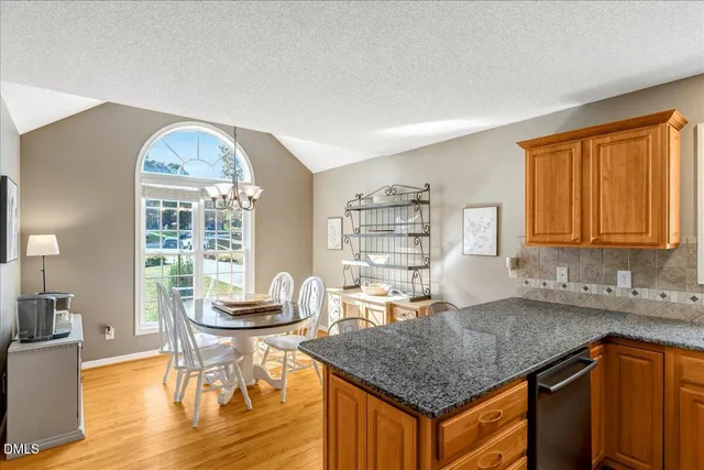 a kitchen with granite countertop a sink and a stove