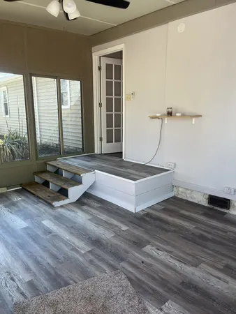 a living room with couch guitar and outer view