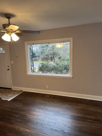 a view of wooden floor chandelier and window in a room