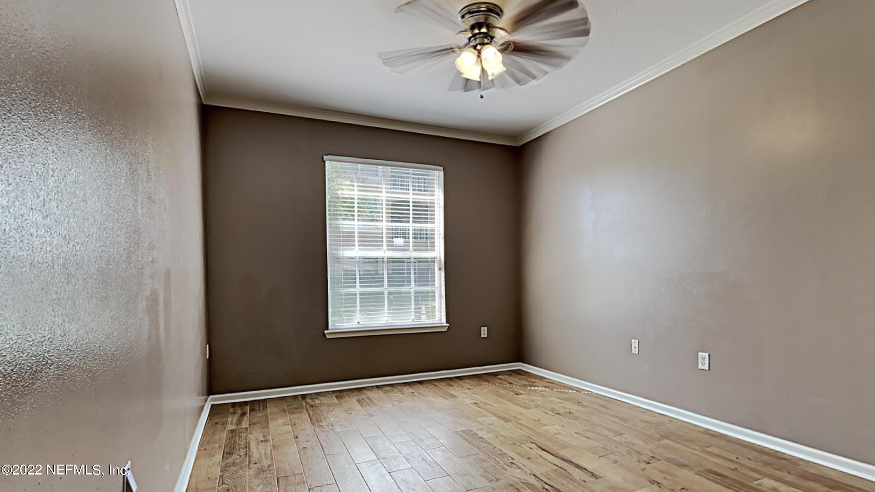 7990 Baymeadows Road, Unit 201 Jacksonville, FL 32256 - Photo 7 of 14 an empty room with windows and fan