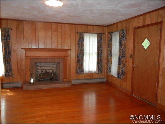 355 South Ridgecrest Street Rutherfordton, NC 28139 - Photo 12 of 24 a view of an empty room with window and fire place