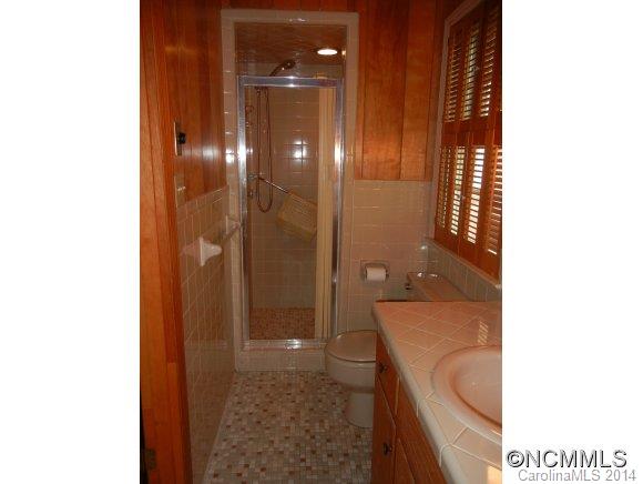 355 South Ridgecrest Street Rutherfordton, NC 28139 - Photo 13 of 24 a bathroom with a granite countertop sink a toilet and shower