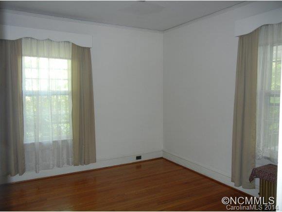 355 South Ridgecrest Street Rutherfordton, NC 28139 - Photo 14 of 24 a view of an empty room with wooden floor and a window