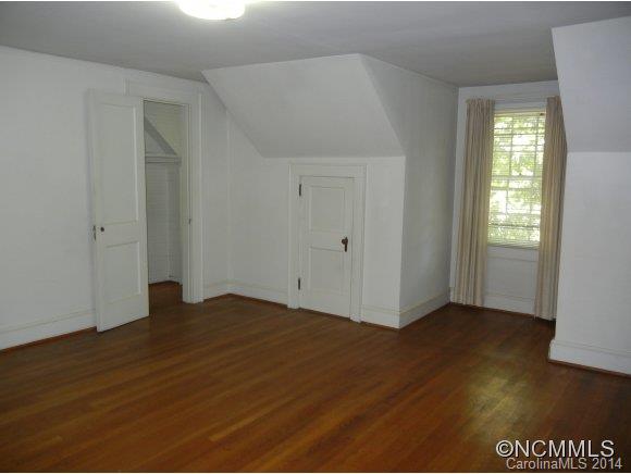 355 South Ridgecrest Street Rutherfordton, NC 28139 - Photo 16 of 24 an empty room with wooden floor and windows
