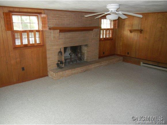 355 South Ridgecrest Street Rutherfordton, NC 28139 - Photo 20 of 24 an empty room with windows fireplace and fans