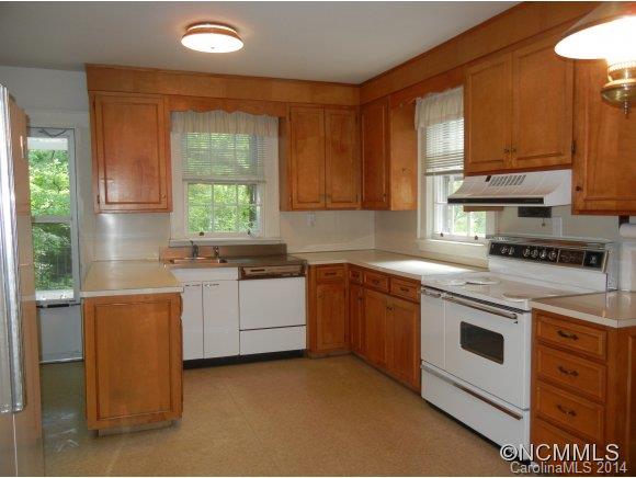 355 South Ridgecrest Street Rutherfordton, NC 28139 - Photo 8 of 24 a kitchen with granite countertop white cabinets and white appliances