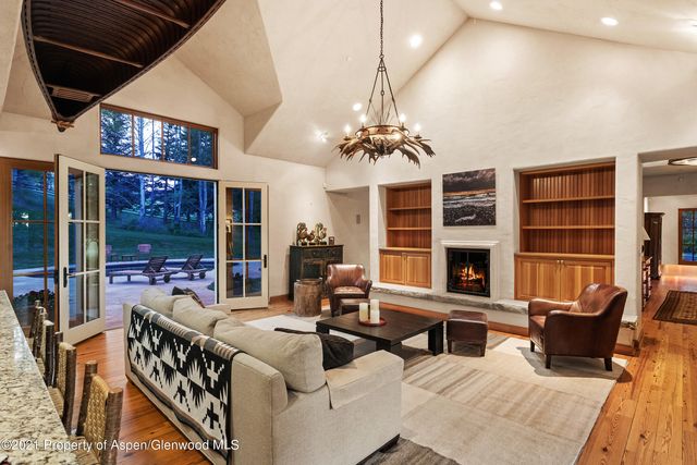 a living room with furniture a lamp and a chandelier