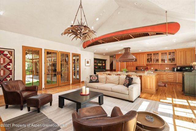a living room with furniture a floor to ceiling window and outdoor view