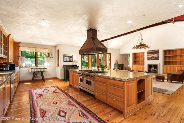 a kitchen with stainless steel appliances granite countertop a stove and cabinets