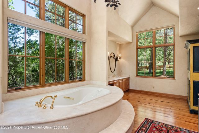 a bathroom with a tub and a window