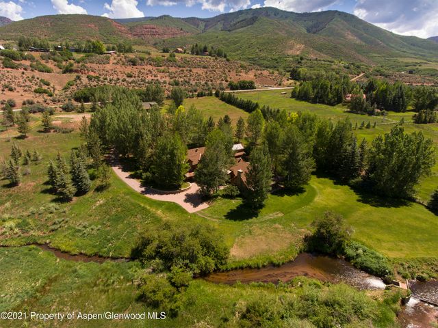 a view of a lush green hillside and houses
