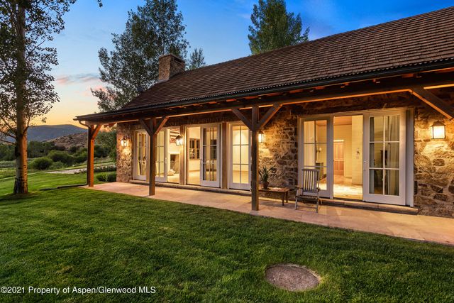 a backyard of a house with lots of green space and fountain