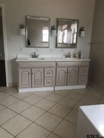 a bathroom with a double vanity sink mirror and double