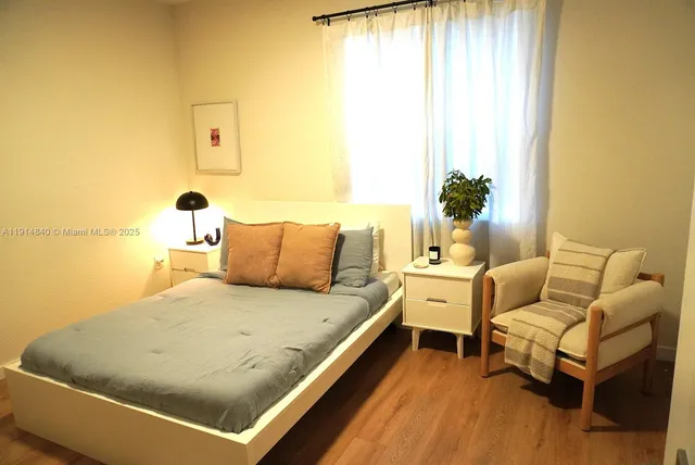 a living room with a bed and a table
