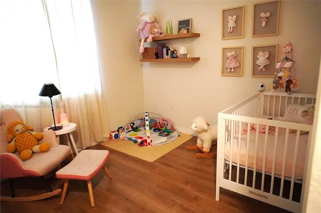 a bedroom with furniture and a wooden floor