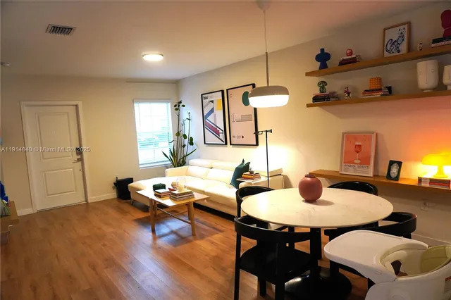 a living room with furniture and wooden floor