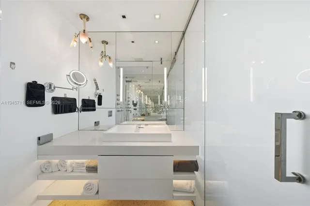 a bathroom with a sink a mirror and shower