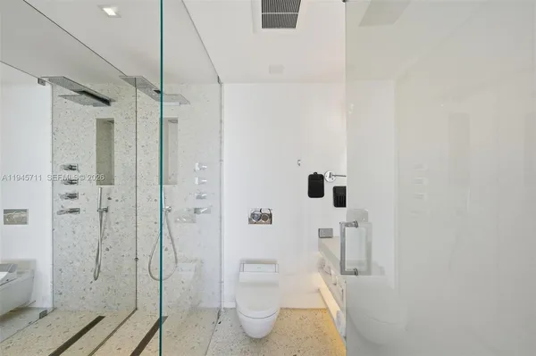 a bathroom with a shower and toilet