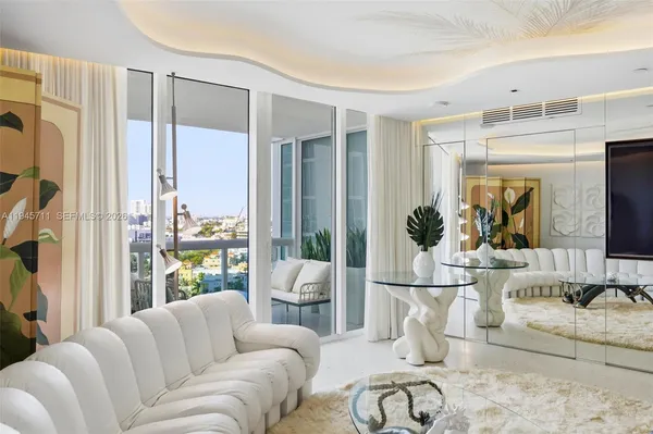 a living room with furniture a large window and flat screen tv
