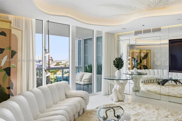 a living room with furniture a large window and flat screen tv