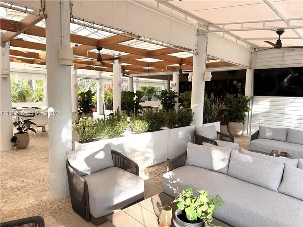 a view of a patio with couches and potted plants