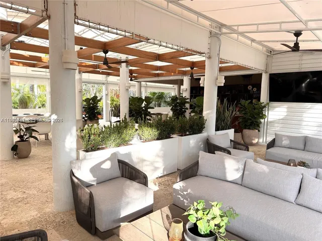 a view of a patio with couches and potted plants