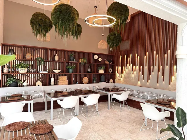 a dining table with chairs and window