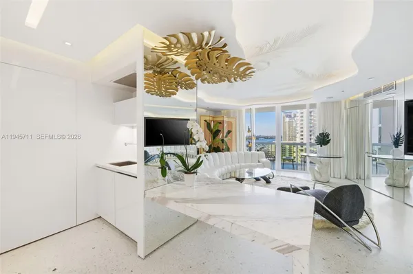 a view of a livingroom with furniture and flat screen tv