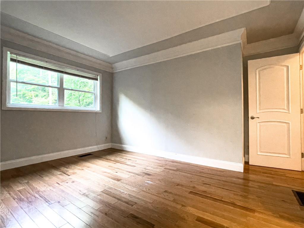 3115 Brookview Road Marietta, GA 30067 - Photo 24 of 31 an empty room with wooden floor and windows