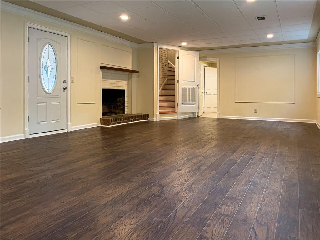 3115 Brookview Road Marietta, GA 30067 - Photo 27 of 31 an empty room with wooden floor cabinet and fireplace
