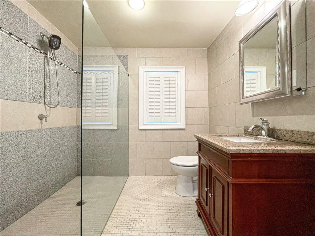 3115 Brookview Road Marietta, GA 30067 - Photo 28 of 31 a bathroom with a granite countertop sink toilet and shower