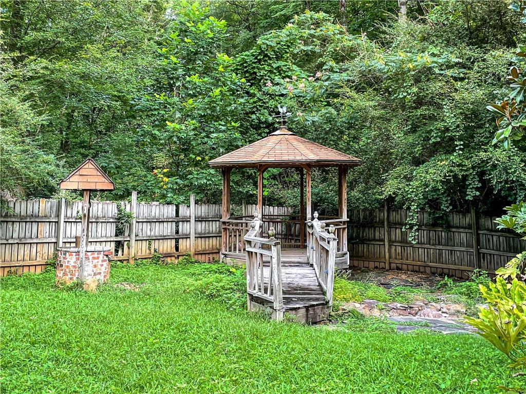 3115 Brookview Road Marietta, GA 30067 - Photo 31 of 31 a view of a chair and table under an umbrella in the backyard