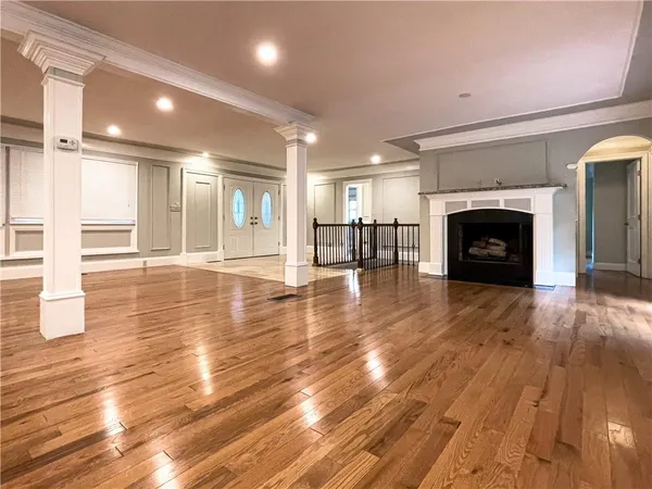 a view of a livingroom with wooden floor and a fireplace