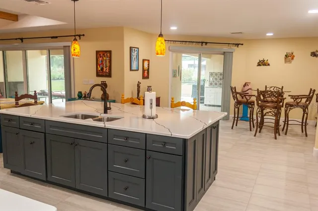 a large kitchen with a table and chairs
