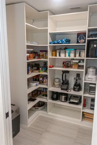 a view of a hallway with wooden floor and windows