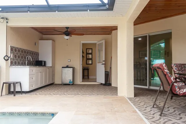 a table and chairs in a room next to a window