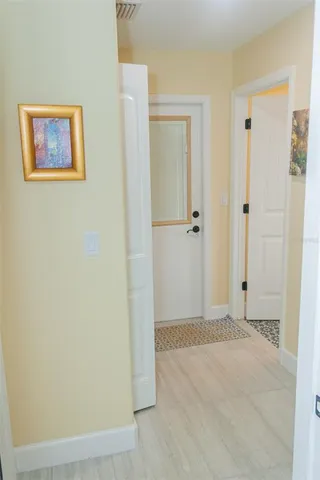 a bedroom with a bed and a flat tv screen on dresser