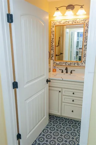 a living room with furniture a flat screen tv and kitchen view