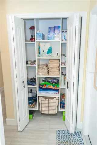 a view of a hallway with wooden floor and closet area