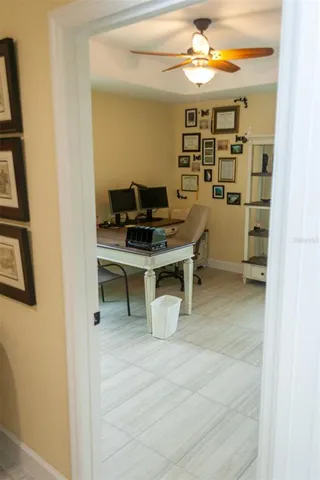 a bedroom with a bed a flat screen tv and paintings on the wall