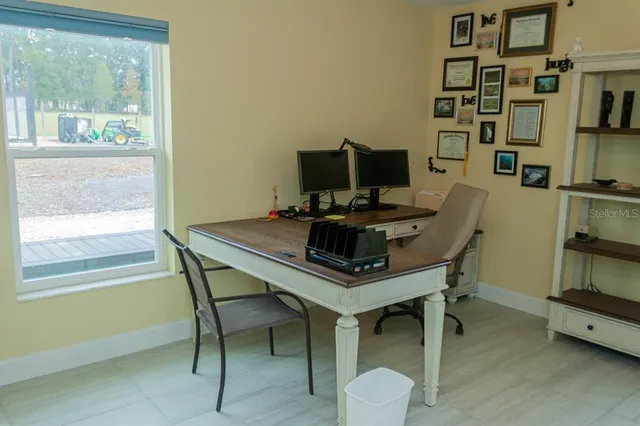 a view of a hallway with wooden floor and a cabinet
