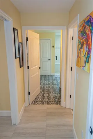 a view of a lake with a floor to ceiling window next to a yard