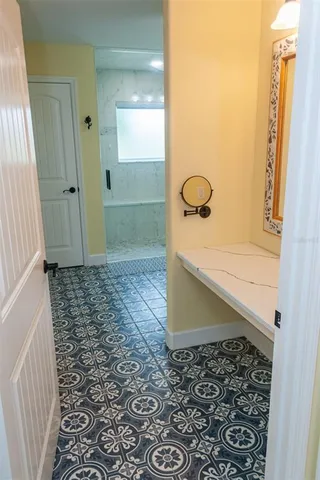 a backyard of a house with barbeque oven table and chairs