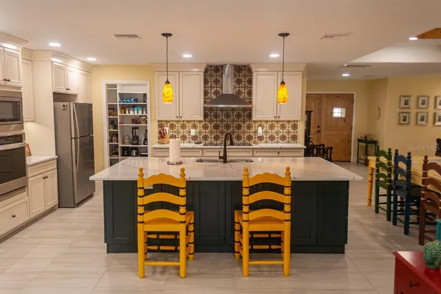 a kitchen with stainless steel appliances a refrigerator and cabinets