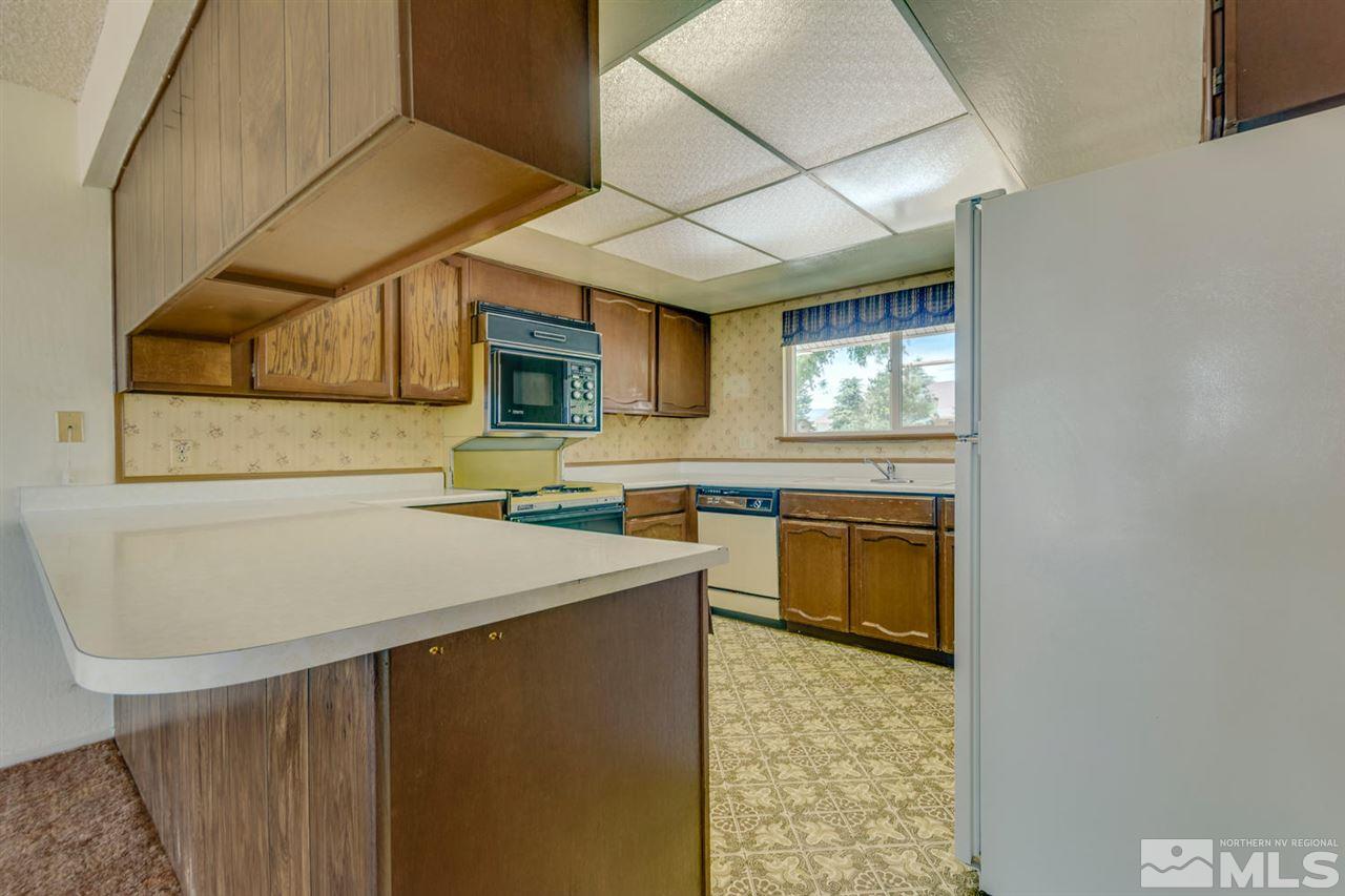 10180 Placerville Road Reno, NV 89508 - Photo 6 of 25 a kitchen with a sink cabinets and wooden floor