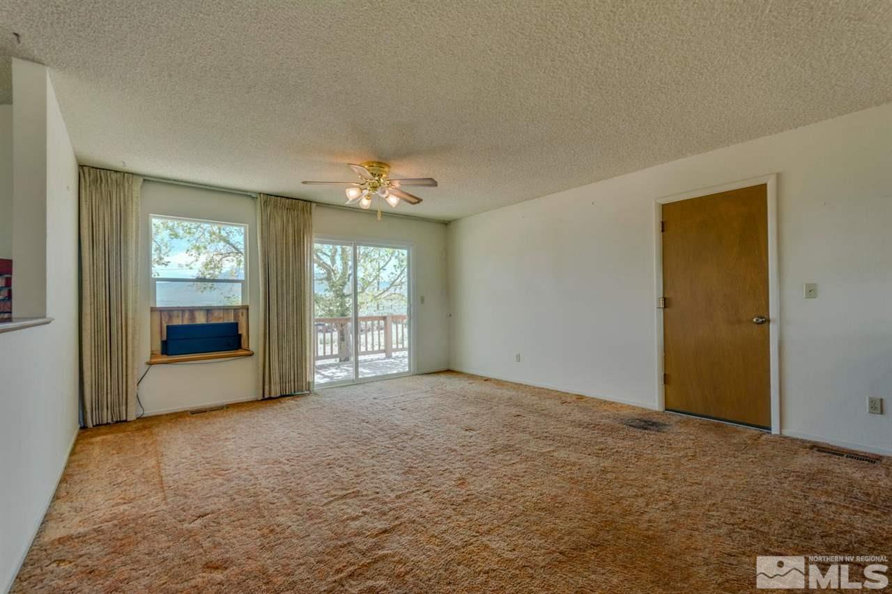 10180 Placerville Road Reno, NV 89508 - Photo 7 of 25 a view of an empty room with chandelier and window