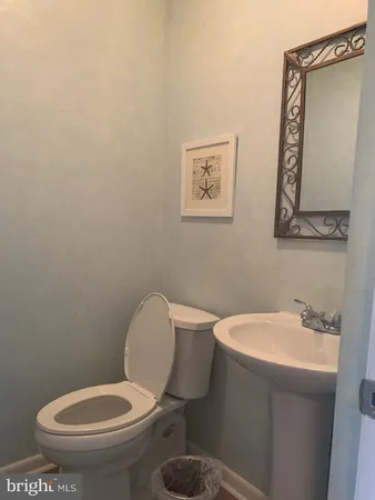 a white toilet sitting next to a bathroom sink