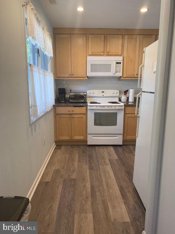 761 Salt Pond Road, Unit A Bethany Beach, DE 19930 - Photo 6 of 16 a kitchen with a white cabinets and white appliances