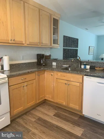 a kitchen with granite countertop cabinets stainless steel appliances and sink