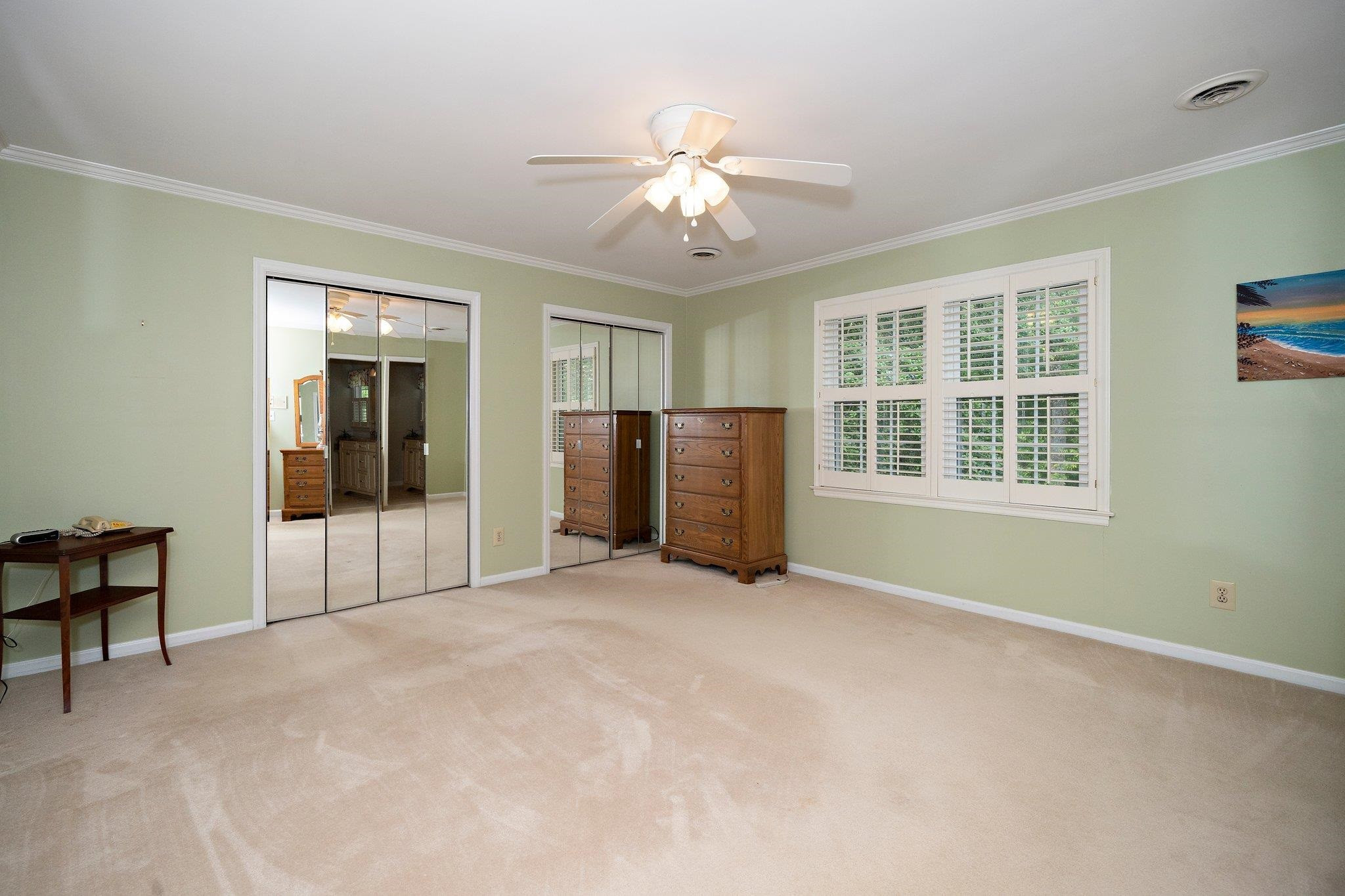 1512 Pony Run Road Raleigh, NC 27615 - Photo 21 of 39 2nd Floor Primary Suite has 2 Mirrored Double Closets + Plantation Shutters Smooth Ceiling and Ceiling Fan Primary Bedroom